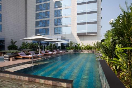 a swimming pool in front of a building at Hyatt Regency Ahmedabad in Ahmedabad