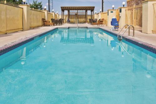 a large swimming pool with blue water at La Quinta Inn and Suites by Wyndham - Schertz in Schertz