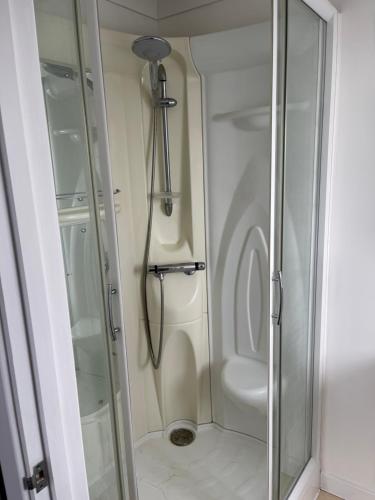 a shower with a glass door in a bathroom at Yare Quays River View in Great Yarmouth