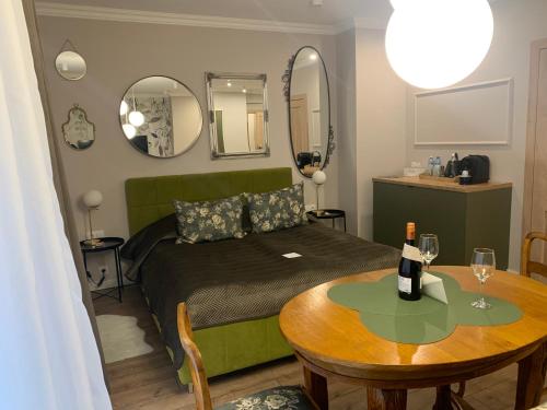 - une chambre avec un lit, une table et des miroirs dans l'établissement Piotrkowska 89 Apartments & Suites, à Łódź