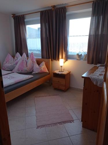 a bedroom with two beds and a window at Kékház Vendégház in Écs