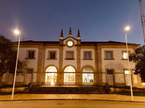 a building with a clock tower on top of it at Thomar House in Tomar