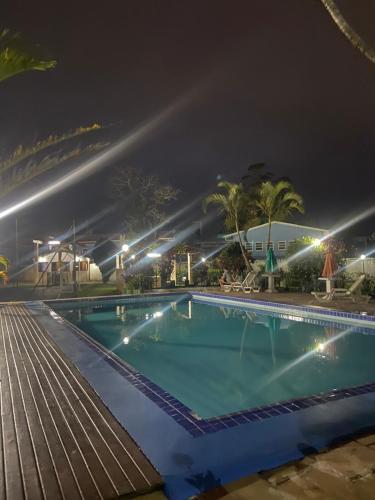 a swimming pool at night with lights at Casa Chale 10 Florianópolis in Florianópolis
