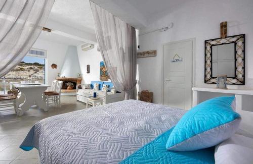 a bedroom with a bed with blue pillows on it at Fani Dream Suite in Pachaina