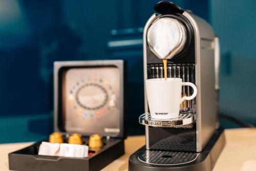 a coffee maker is making a cup of coffee at Hallstatt Hideaway - Adults only in Hallstatt
