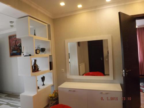 a room with a mirror on the wall at Sweet Home in Kutaisi