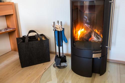a fireplace with a bag and a shopping bag next to it at Hallstatt Hideaway - Adults only in Hallstatt
