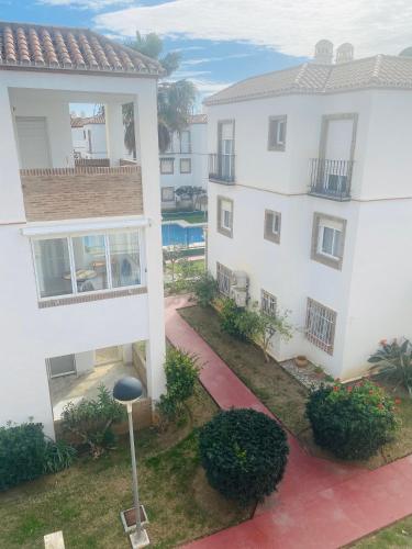 an aerial view of a white building with a courtyard at Casa Pandora Apartamento Duplex Atico, primera línea de playa Torrox in Torrox Costa