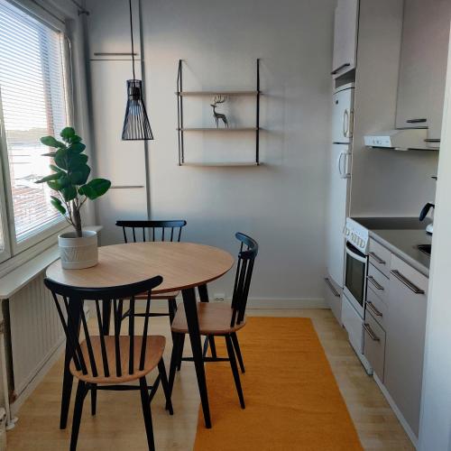 uma cozinha com mesa e cadeiras num quarto em Huoneisto rantabulevardilla, 1-4 hengelle em Savonlinna