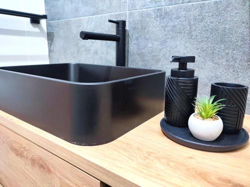 a black sink on a counter in a bathroom at Apartament DanHouse in Giżycko