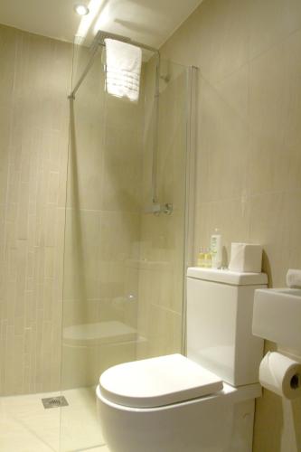 a bathroom with a shower and a toilet and a sink at Accommodation Bristol Airport in Redhill