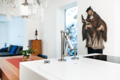 a kitchen counter with a sink and a painting on the wall at Hallstatt Hideaway - Adults only in Hallstatt