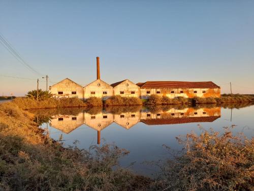 a row of houses reflected in a body of water at Central Tavira apartment, Casa Oliverio in Tavira