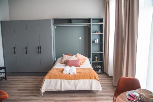 a bedroom with a bed with two towels on it at Cozy studio by the city centre in Reykjavík