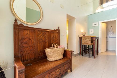 a mirror on a wall above a wooden bench in a room at Entre Bodegas Jerez in Jerez de la Frontera