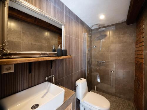 een badkamer met een wastafel, een toilet en een douche bij WILLOW in Pāvilosta