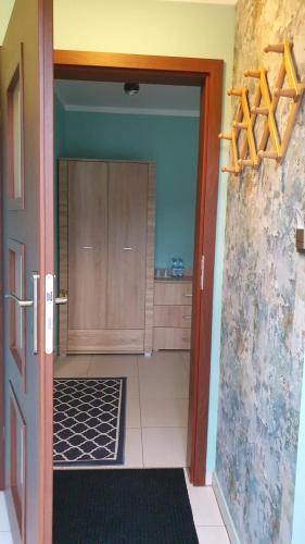 a room with a door open to a kitchen at Chata nad Sztolnią in Bystrzyca Górna