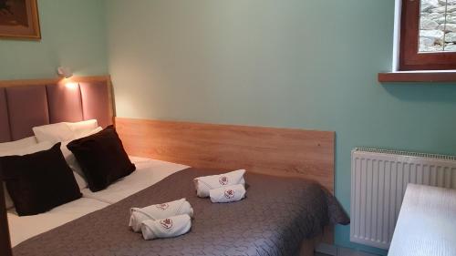 a bedroom with a bed with two pillows on it at Chata nad Sztolnią in Bystrzyca Górna