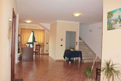 a living room with a table and a staircase at San Nicola Il Sole in Albanella