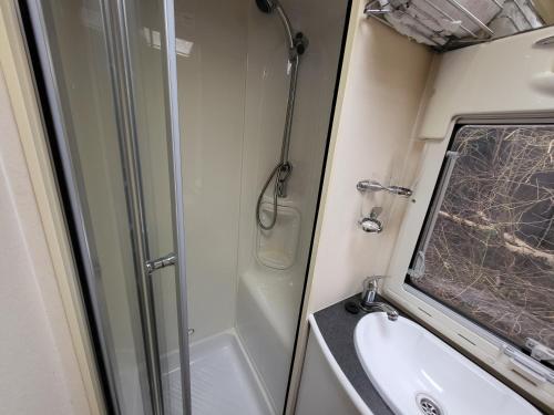 a bathroom with a shower and a sink at Glamping with Llamas in Wisbech