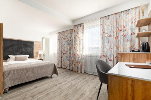 um quarto de hotel com uma cama e uma janela em Hotel am Ludwigsplatz em Giessen