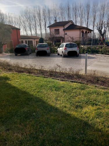 three cars parked in a parking lot in front of a house at RB Bed & Breakfast in Gaiba