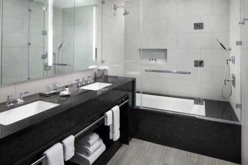 a bathroom with two sinks and a large mirror at The St. Anthony, a Luxury Collection Hotel, San Antonio in San Antonio