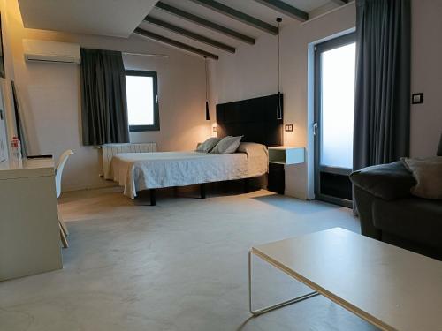 a hotel room with a bed and a couch at Ardigales 11 in Castro-Urdiales