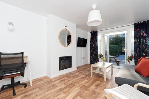 a living room with a couch and a fireplace at Modern, but cosy Bungalow in Queensbury