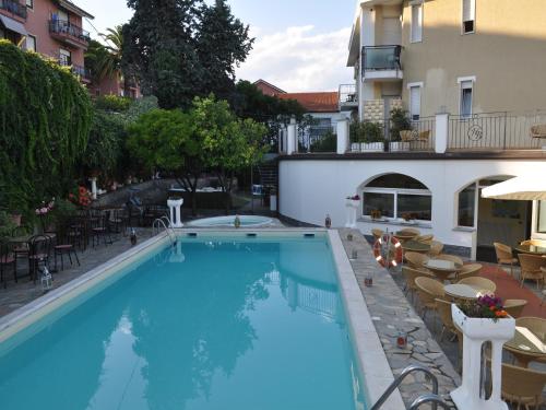 a large blue swimming pool next to a building at Hotel Bellavista in San Bartolomeo al Mare
