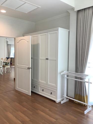 a white cabinet in a room with a table at Seapine Beach Golf and Resort Hua Hin in Hua Hin