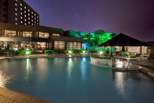 a large pool of water in front of a building at night at Marriott São Paulo Airport Hotel in Guarulhos