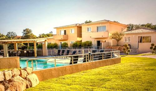 a house with a swimming pool in a yard at Residence Casa Di Paoli in Porto-Vecchio