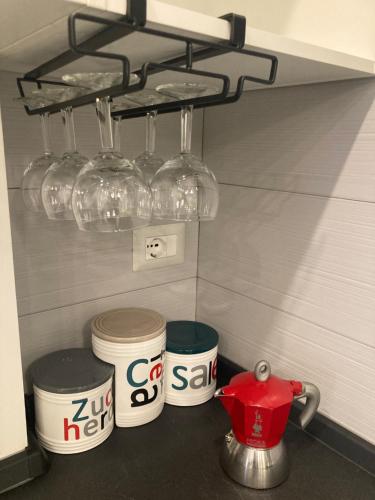 a kitchen counter with three cups and a tea pot at CASA TUA in Ivrea