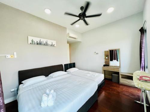 a bedroom with a large bed with a ceiling fan at AJ Suites @ Loft Imago KK in Kota Kinabalu