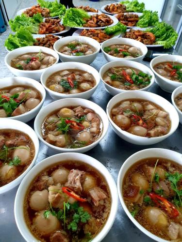 a bunch of bowls of food on a table at Mũi Dinh Hotel in Phan Rang