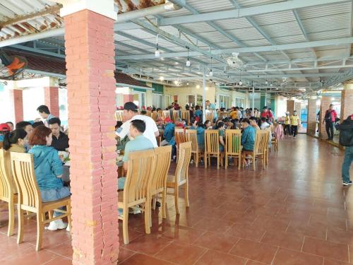 a group of people sitting at tables in a building at Mũi Dinh Hotel in Phan Rang