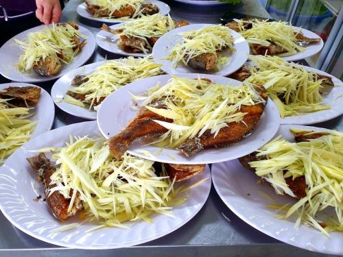 a bunch of plates of food on a table at Mũi Dinh Hotel in Phan Rang