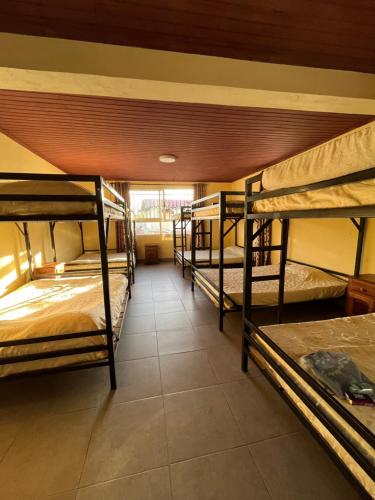 a room with three bunk beds in a room at Hôtel - Appartement meublé " LES FLOTS BLEU " in Antananarivo