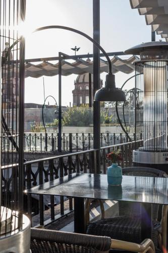 a table on a balcony with a view of the water at Casa 1810 Hotel Boutique in San Miguel de Allende