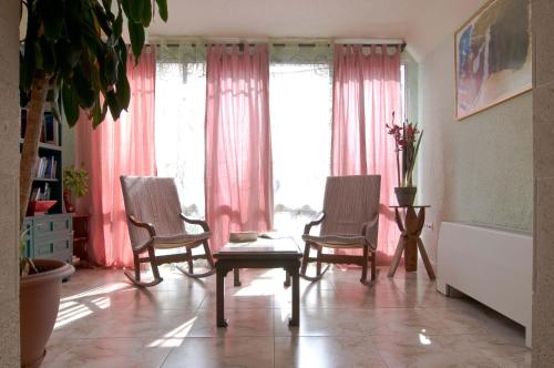 a living room filled with furniture next to a window at Hotel Balear in Can Pastilla