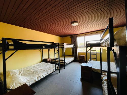 a room with two bunk beds and a window at Hôtel - Appartement meublé " LES FLOTS BLEU " in Antananarivo