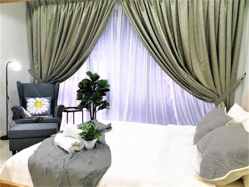 a bedroom with a bed and a chair and a window at FlexiHome Studio Newly Renovate - 1 Queen 2 Single in Petaling Jaya