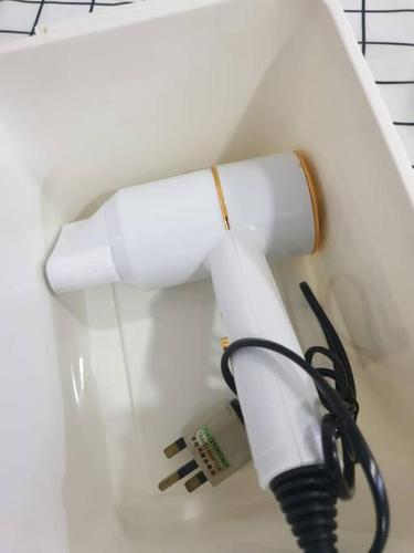a white telephone with a cord in a room at FlexiHome Studio Newly Renovate - 1 Queen 2 Single in Petaling Jaya