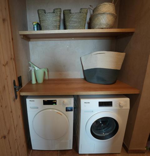 a laundry room with a washer and dryer on a shelf at Löberbauer, Ferienwohnung in Tux