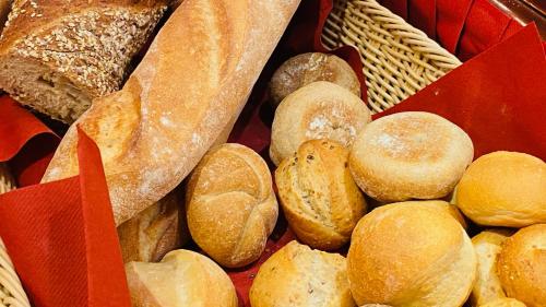 a bunch of different types of bread in a basket at Boutique Hotel Belle Epoque in Bern
