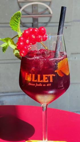 a drink in a wine glass on a red table at Boutique Hotel Belle Epoque in Bern