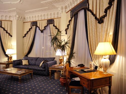 a living room with a couch and a table at Grand Hotel Ukraine in Dnipro