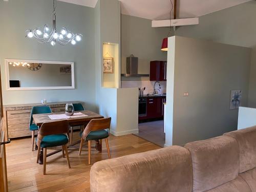 a living room and kitchen with a table and a couch at Maison familiale 3 chambres in Avignon