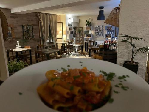 a plate of food on top of a restaurant at Hotel Sa Lumenera in Bosa